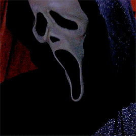 Ghostface from the movie Scream nodding his head. He has a long, white face and a black cloak. The background is a dark red.